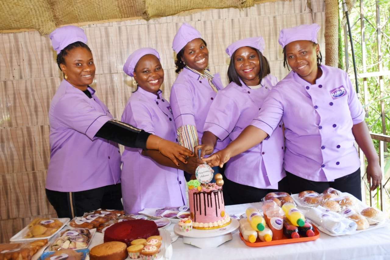 MCBGEI trainers in uniform celebrating with a cake